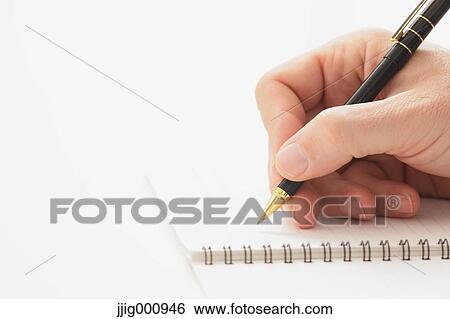 Close up of male hand writing on notebook View Large Photo Image Stock Photograph - Close up of male hand writing on notebook. Fotosearch