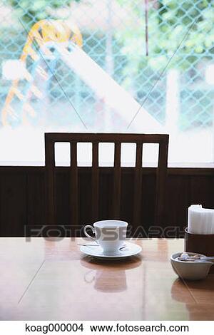 Picture - Coffee cup on wooden table in a cafe. Fotosearch