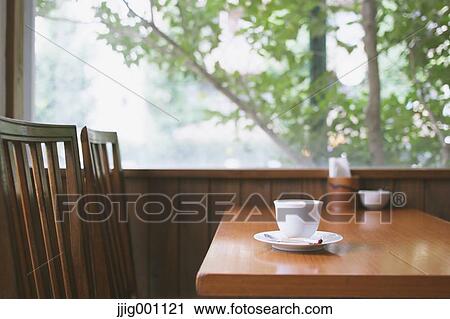 Stock Image - Coffee on wooden table in a cafe. Fotosearch