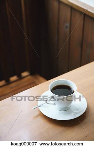 Coffee on wooden table in a cafe View Large Photo Image Stock Photo - Coffee on wooden table in a cafe. Fotosearch