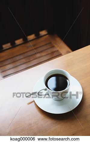 Stock Photograph - Coffee on wooden table in a cafe. Fotosearch