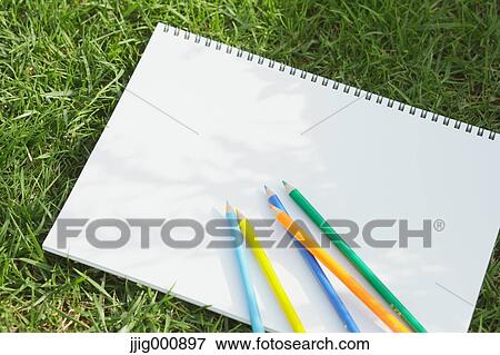 Colored pencil and sketchbook on grass View Large Photo Image Stock Photo - Colored pencil and sketchbook on grass. Fotosearch