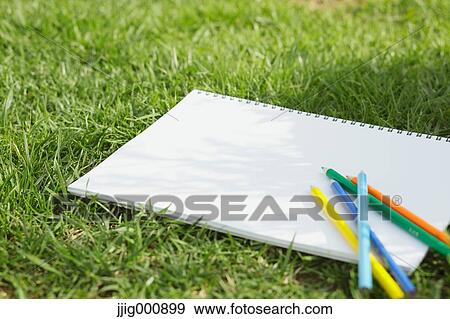 Colored pencil and sketchbook on grass View Large Photo Image Stock Photo - Colored pencil and sketchbook on grass. Fotosearch