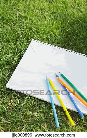 Colored pencil and sketchbook on grass View Large Photo Image Stock Photograph - Colored pencil and sketchbook on grass. Fotosearch