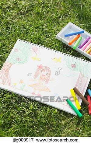 Crayons and drawing on grass View Large Photo Image Stock Photo - Crayons and drawing on grass. Fotosearch