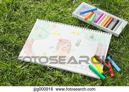 Crayons and drawing on grass View Large Photo Image Stock Photograph - Crayons and drawing on grass. Fotosearch