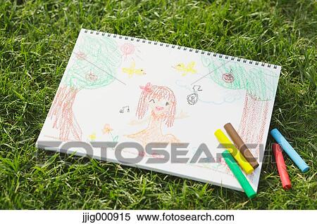 Stock Photography - Crayons and drawing on grass. Fotosearch