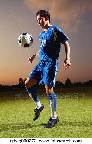 Football player in a blue uniform lifting ball View Large Photo Image Stock Image - Football player in a blue uniform lifting ball. Fotosearch