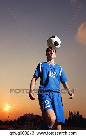 Football player in a blue uniform lifting ball View Large Photo Image Stock Image - Football player in a blue uniform lifting ball. Fotosearch