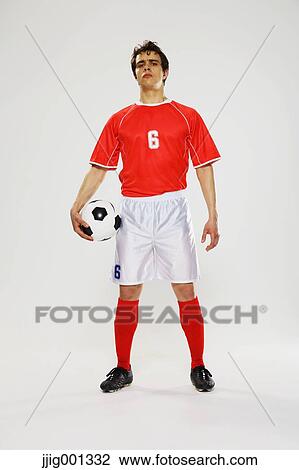 Football player in a white and red uniform standing against white background View Large Photo Image Stock Image - Football player in a white and red uniform standing against white background. Fotosearch