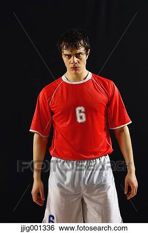 Football player in a white and red uniform standing against black background View Large Photo Image Stock Photograph - Football player in a white and red uniform standing against black background. Fotosearch