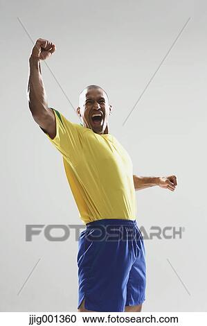Football player in a yellow and blue uniform standing against white background View Large Photo Image Stock Image - Football player in a yellow and blue uniform standing against white background. Fotosearch