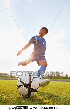 Football player kicking ball View Large Photo Image Stock Photograph - Football player kicking ball. Fotosearch