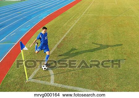 Picture - Football player taking a corner kick. Fotosearch