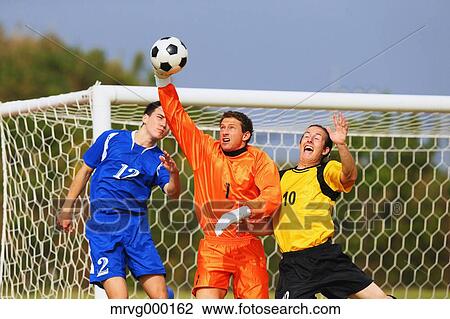 Football players aiming for the ball View Large Photo Image Stock Image - Football players aiming for the ball. Fotosearch