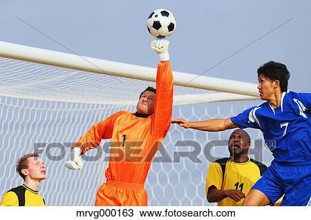 Football players aiming for the ball View Large Photo Image Stock Image - Football players aiming for the ball. Fotosearch
