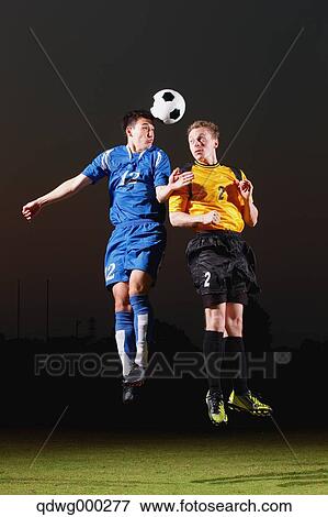 Football players aiming for the ball View Large Photo Image Stock Photo - Football players aiming for the ball. Fotosearch