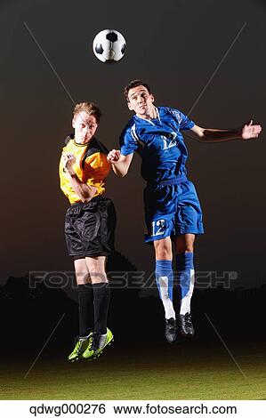 Football players aiming for the ball View Large Photo Image Stock Photograph - Football players aiming for the ball. Fotosearch