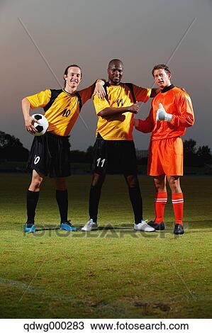 Football players posing with ball View Large Photo Image Stock Image - Football players posing with ball. Fotosearch