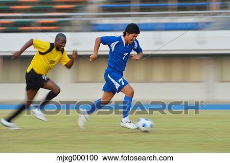 Football players running with ball View Large Photo Image Stock Image - Football players running with ball. Fotosearch