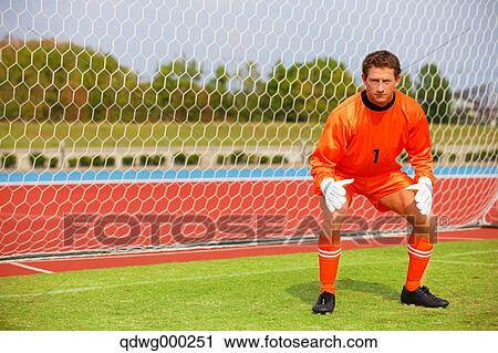 Goalkeeper in orange uniform standing in soccer field View Large Photo Image Stock Image - Goalkeeper in orange uniform standing in soccer field. Fotosearch
