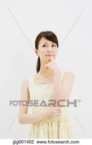 Japanese young woman in a one piece dress standing against white background View Large Photo Image Stock Image - Japanese young woman in a one piece dress standing against white background. Fotosearch