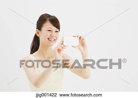 Japanese young woman in a one piece dress with smartphone against white background View Large Photo Image Stock Image - Japanese young woman in a one piece dress with smartphone against white background. Fotosearch