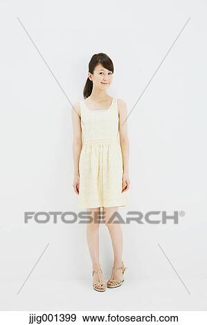 Japanese young woman in a one piece dress standing against white background View Large Photo Image Stock Photo - Japanese young woman in a one piece dress standing against white background. Fotosearch