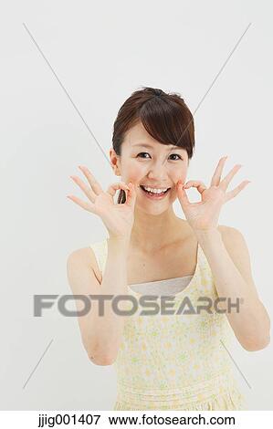 Japanese young woman in a one piece dress standing against white background View Large Photo Image Stock Photo - Japanese young woman in a one piece dress standing against white background. Fotosearch