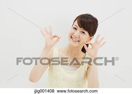 Japanese young woman in a one piece dress standing against white background View Large Photo Image Stock Photo - Japanese young woman in a one piece dress standing against white background. Fotosearch