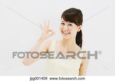 Stock Photo - Japanese young woman in a one piece dress standing against white background. Fotosearch
