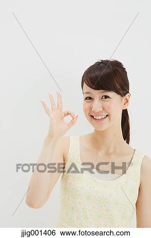 Japanese young woman in a one piece dress standing against white background View Large Photo Image Stock Photograph - Japanese young woman in a one piece dress standing against white background. Fotosearch