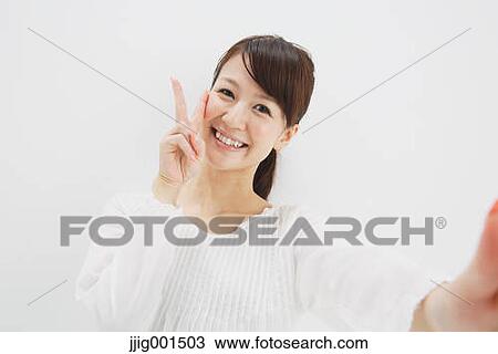 Japanese young woman in a white shirt against white background View Large Photo Image Stock Image - Japanese young woman in a white shirt against white background. Fotosearch