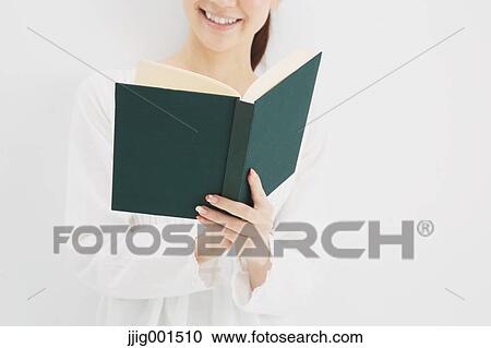 Japanese young woman in a white shirt with a book against white background View Large Photo Image Stock Image - Japanese young woman in a white shirt with a book against white background. Fotosearch