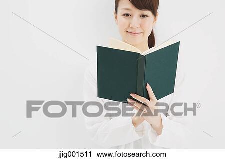 Japanese young woman in a white shirt with a book against white background View Large Photo Image Stock Image - Japanese young woman in a white shirt with a book against white background. Fotosearch
