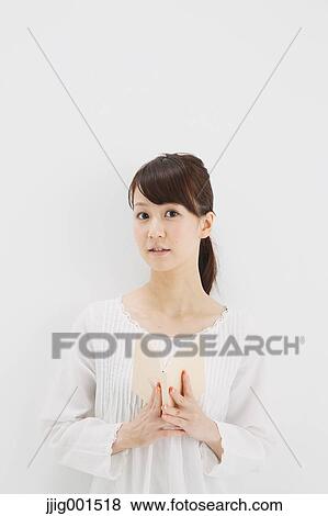 Japanese young woman in a white shirt with a book against white background View Large Photo Image Stock Photo - Japanese young woman in a white shirt with a book against white background. Fotosearch