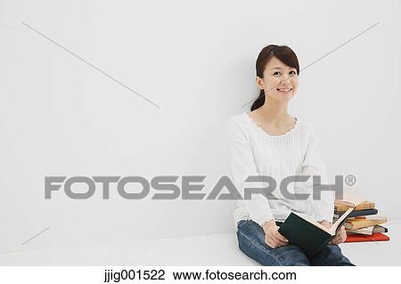 Japanese young woman in jeans and white shirt with a book against white background View Large Photo Image Stock Image - Japanese young woman in jeans and white shirt with a book against white background. Fotosearch