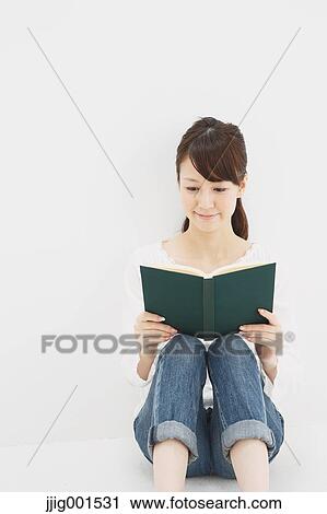 Japanese young woman in jeans and white shirt with a book against white background View Large Photo Image Stock Image - Japanese young woman in jeans and white shirt with a book against white background. Fotosearch
