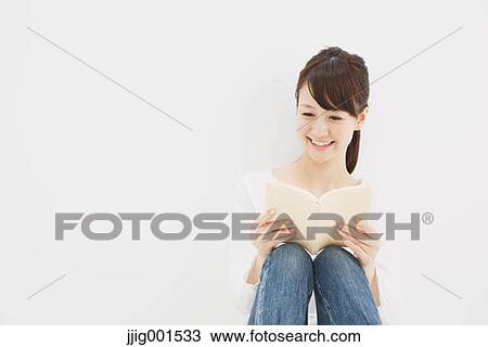 Japanese young woman in jeans and white shirt with a book against white background View Large Photo Image Stock Image - Japanese young woman in jeans and white shirt with a book against white background. Fotosearch
