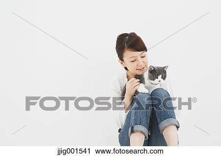 Japanese young woman in jeans and white shirt with cat View Large Photo Image Stock Image - Japanese young woman in jeans and white shirt with cat. Fotosearch