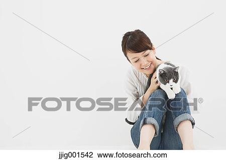 Japanese young woman in jeans and white shirt with cat View Large Photo Image Stock Image - Japanese young woman in jeans and white shirt with cat. Fotosearch