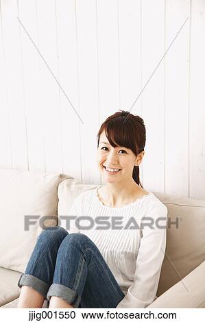 Japanese young woman in jeans and white shirt on the sofa View Large Photo Image Stock Image - Japanese young woman in jeans and white shirt on the sofa. Fotosearch
