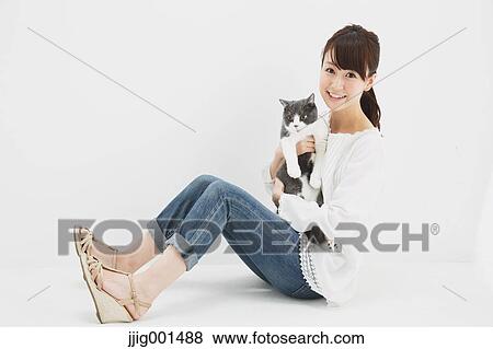 Japanese young woman in jeans and white shirt with cat View Large Photo Image Stock Photo - Japanese young woman in jeans and white shirt with cat. Fotosearch