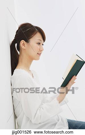 Japanese young woman in jeans and white shirt with a book against white background View Large Photo Image Stock Photograph - Japanese young woman in jeans and white shirt with a book against white background. Fotosearch