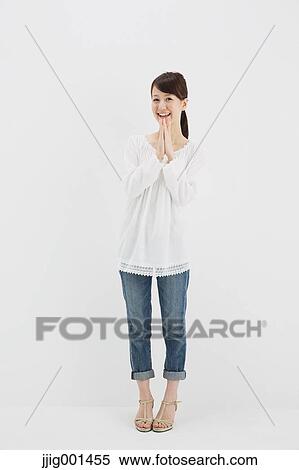 Japanese young woman in jeans and white shirt standing against white background View Large Photo Image Stock Photography - Japanese young woman in jeans and white shirt standing against white background. Fotosearch