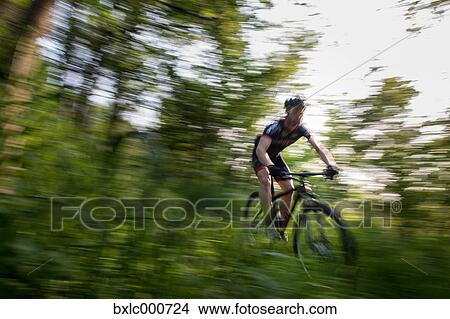 Man riding mountain bike in nature in the Bologna countryside, Italy View Large Photo Image Picture - Man riding mountain bike in nature in the Bologna countryside, Italy. Fotosearch