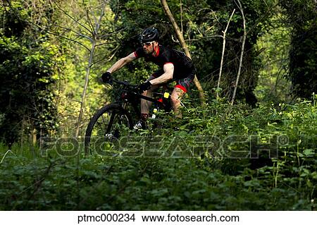 Man riding mountain bike in nature in the Bologna countryside, Italy View Large Photo Image Picture - Man riding mountain bike in nature in the Bologna countryside, Italy. Fotosearch