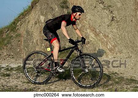 Man riding mountain bike in nature in the Bologna countryside, Italy View Large Photo Image Picture - Man riding mountain bike in nature in the Bologna countryside, Italy. Fotosearch