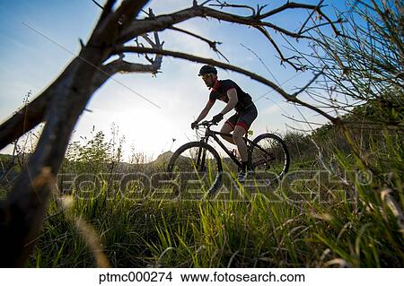 Picture - Man riding mountain bike in nature in the Bologna countryside, Italy. Fotosearch