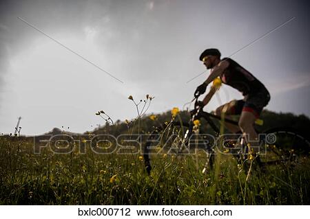 Man riding mountain bike in nature in the Bologna countryside, Italy View Large Photo Image Stock Image - Man riding mountain bike in nature in the Bologna countryside, Italy. Fotosearch